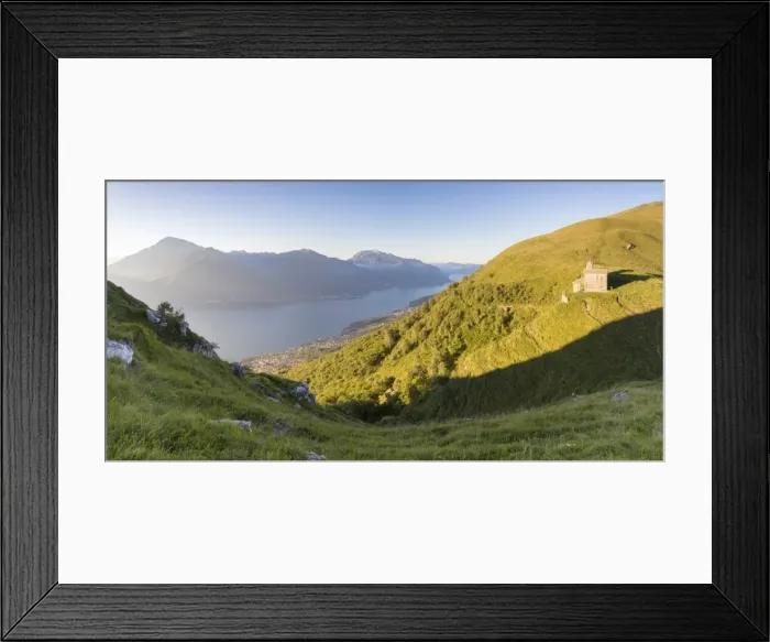 Framed Print : Sun on Church of San Bernardo lights up the landscape around the blue water of Lake Como at dawn Framed Print : Sun on Church of San Bernardo lights up the landscape around the blue water of Lake Como at dawn