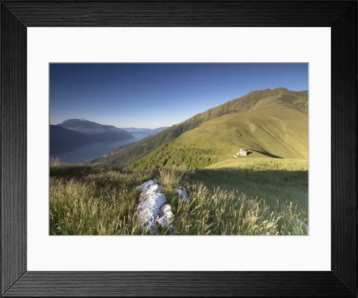 Framed Print : Sunbeam on Church of San Bernardo lights up the landscape around the blue water of Framed Print : Sunbeam on Church of San Bernardo lights up the landscape around the blue water of