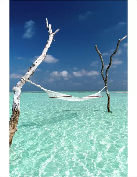 Hammock over the waters of a tropical lagoon, The Maldives, Indian Ocean, Asia