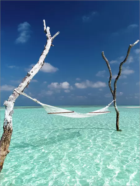 Hammock over the waters of a tropical lagoon, The Maldives, Indian Ocean, Asia