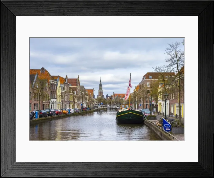 Framed Print : Buildings along the Luttik Oudorp canal and the tower of the Waaggebouw (The Waag) weigh house Framed Print : Buildings along the Luttik Oudorp canal and the tower of the Waaggebouw (The Waag) weigh house