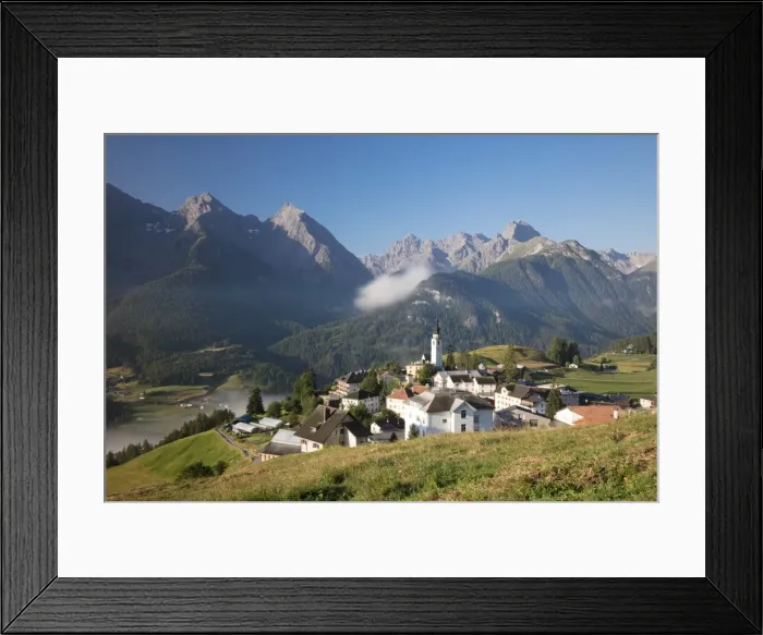 Framed Print : Green meadows frame the the alpine village of Ftan, Inn district, Canton of Graubunden Framed Print : Green meadows frame the the alpine village of Ftan, Inn district, Canton of Graubunden