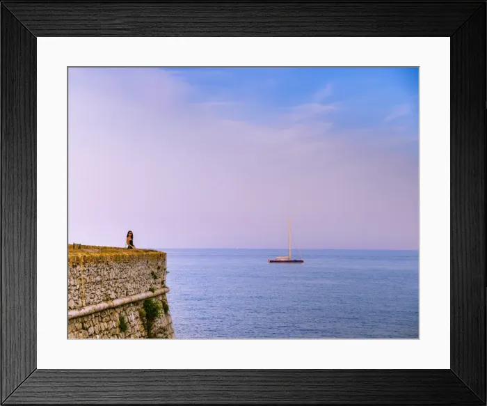 Framed Print : Woman alone at sunset next to the sea, Antibes, Cote d Azur, French Riviera, France Framed Print : Woman alone at sunset next to the sea, Antibes, Cote d Azur, French Riviera, France
