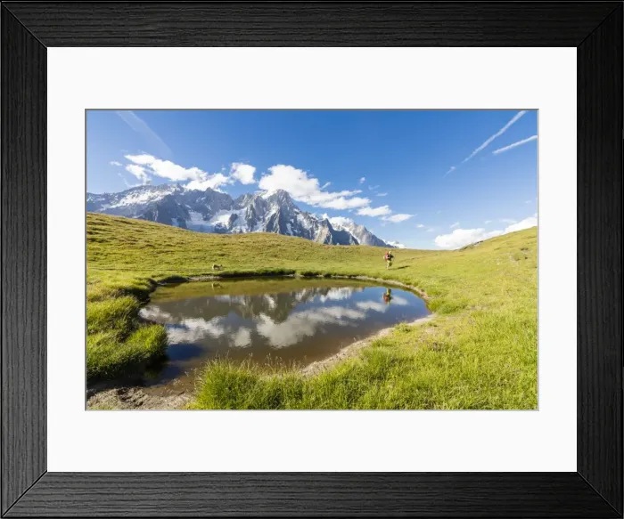 Framed Print : Hiker with dog admires the peaks of Mont De La Saxe reflected in water, Courmayeur Framed Print : Hiker with dog admires the peaks of Mont De La Saxe reflected in water, Courmayeur