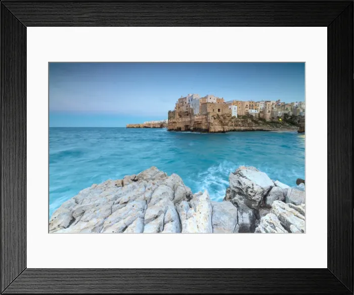 Framed Print : Turquoise sea at dusk framed by the old town perched on the rocks, Polignano a Mare Framed Print : Turquoise sea at dusk framed by the old town perched on the rocks, Polignano a Mare