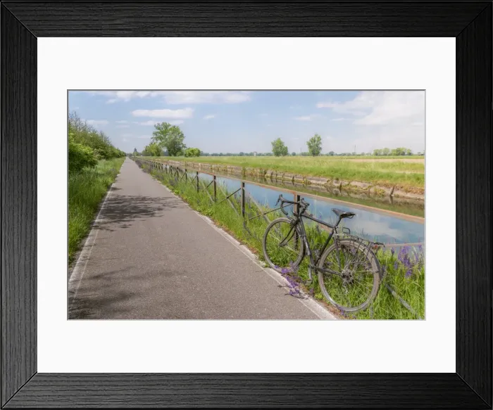Framed Print : A bike on the rail of the Naviglio Pavense canal which links Milan to Pavia which Framed Print : A bike on the rail of the Naviglio Pavense canal which links Milan to Pavia which