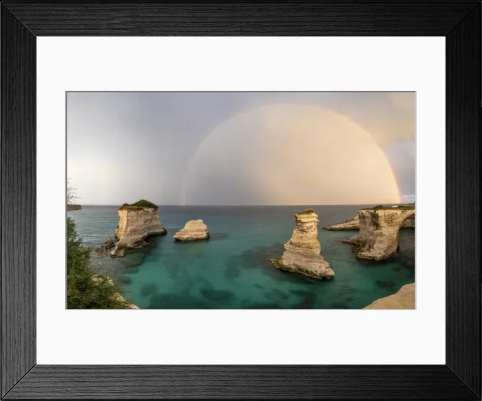 Framed Print : Rainbow frames rocky cliffs known as Faraglioni di Sant andrea surrounded by turquoise sea Framed Print : Rainbow frames rocky cliffs known as Faraglioni di Sant andrea surrounded by turquoise sea