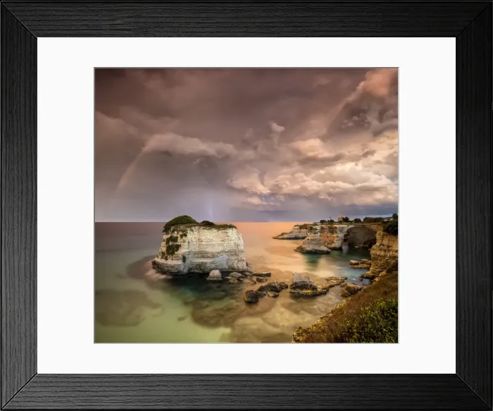 Framed Print : Rainbow and lightning after the storm on cliffs known as Faraglioni di Sant Andrea Framed Print : Rainbow and lightning after the storm on cliffs known as Faraglioni di Sant Andrea