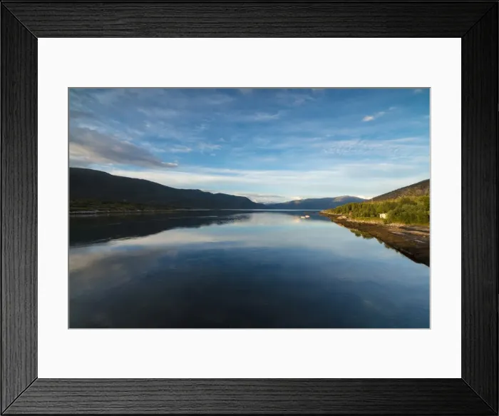 Framed Print : Light of the midnight sun illuminates the clear water of blue sea and green woods Framed Print : Light of the midnight sun illuminates the clear water of blue sea and green woods