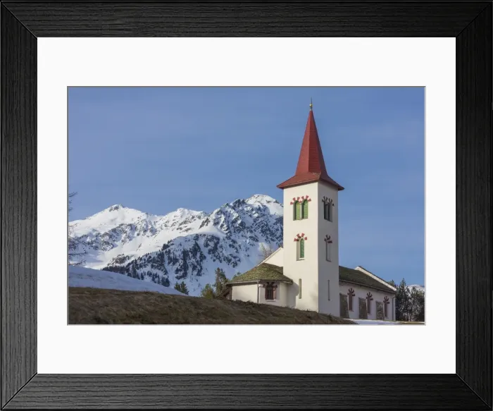 Framed Print : The white alpine church framed by snowy peaks, Maloja, Bregaglia Valley, Canton of Graubunden Framed Print : The white alpine church framed by snowy peaks, Maloja, Bregaglia Valley, Canton of Graubunden
