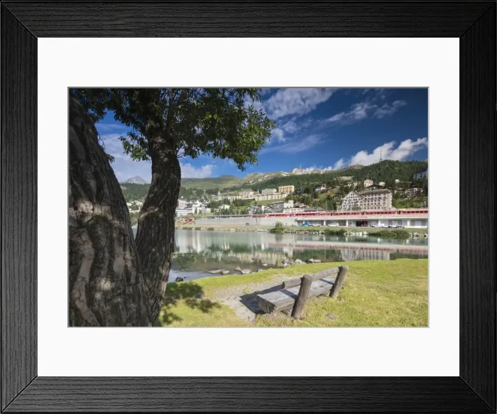 Framed Print : Bernina Express train runs past the village of St. Moritz surrounded by lake, Canton of Graubunden Framed Print : Bernina Express train runs past the village of St. Moritz surrounded by lake, Canton of Graubunden