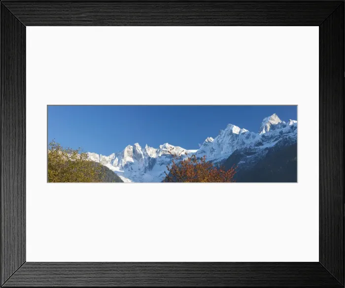 Framed Print : Panorama of the snowy peaks framed by colorful trees, Soglio, Bregaglia Valley, Canton Framed Print : Panorama of the snowy peaks framed by colorful trees, Soglio, Bregaglia Valley, Canton