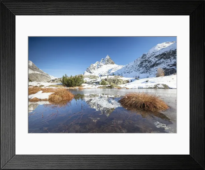 Framed Print : Snowy peaks are reflected in the alpine lake partially frozen, Lejets Crap Alv (Crap Alv Laiets) Framed Print : Snowy peaks are reflected in the alpine lake partially frozen, Lejets Crap Alv (Crap Alv Laiets)