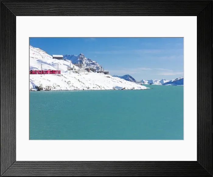 Framed Print : Bernina Express train in the snowy valley surrounded by Lake Bianco, Bernina Pass Framed Print : Bernina Express train in the snowy valley surrounded by Lake Bianco, Bernina Pass