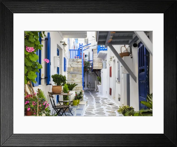 Framed Print : Narrow street, whitewashed buildings with blue paint work, flowers, Mykonos Town (Chora) Framed Print : Narrow street, whitewashed buildings with blue paint work, flowers, Mykonos Town (Chora)