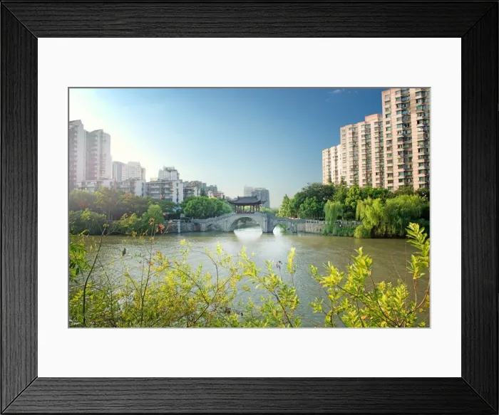 Framed Print : Stone bridge with pagoda style roofing, flanked by old style apartment buildings on the left Framed Print : Stone bridge with pagoda style roofing, flanked by old style apartment buildings on the left