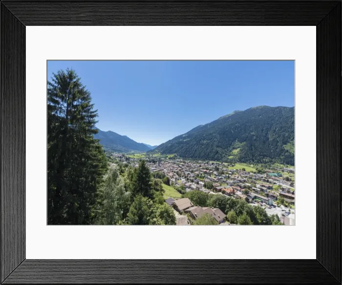 Framed Print : Blue sky and woods frame the alpine village of Pinzolo, Brenta Dolomites, Trentino-Alto Adige Framed Print : Blue sky and woods frame the alpine village of Pinzolo, Brenta Dolomites, Trentino-Alto Adige
