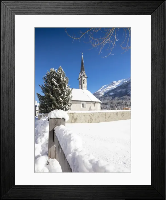 Framed Print : Alpine church covered with snow framed by blue sky, Cinuos, Canton of Graubunden Framed Print : Alpine church covered with snow framed by blue sky, Cinuos, Canton of Graubunden