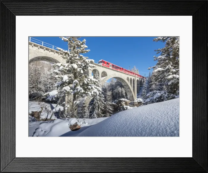 Framed Print : The red train on viaduct surrounded by snowy woods, Cinuos-Chel, Canton of Graubunden Framed Print : The red train on viaduct surrounded by snowy woods, Cinuos-Chel, Canton of Graubunden