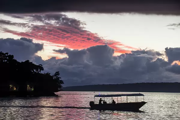 Tourist boat driving back home at sunset in Port Vila, Efate, Vanuatu, Pacific
