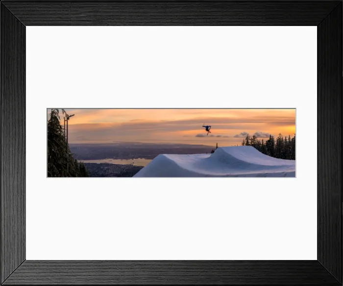 Framed Print : Freestyle skier doing a trick off a jump above city at sunset, Canada, North America Framed Print : Freestyle skier doing a trick off a jump above city at sunset, Canada, North America