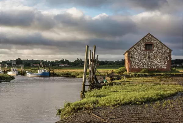 A view of boats moored in the creek at Thornham, Norfolk, England, United Kingdom, Europe