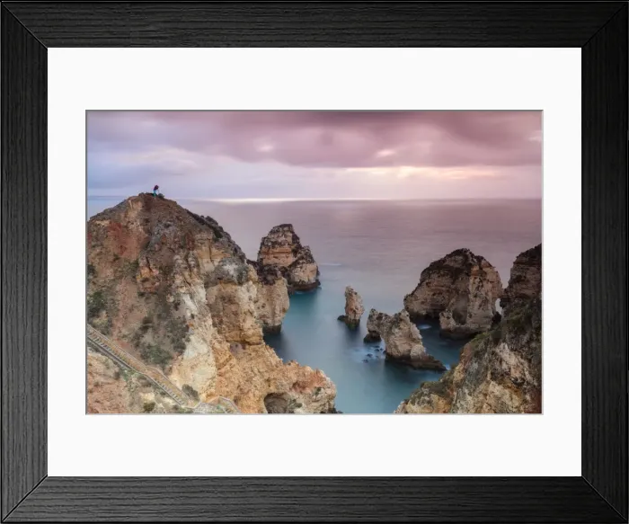 Framed Print : Photographer on top of cliffs surrounded by sea under the pink sky at sunrise, Ponta Da Piedade Framed Print : Photographer on top of cliffs surrounded by sea under the pink sky at sunrise, Ponta Da Piedade
