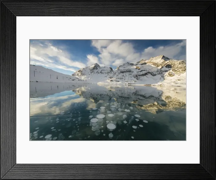 Framed Print : Ice bubbles frame the snowy peaks reflected in Lago Bianco, Bernina Pass, canton of Graubunden Framed Print : Ice bubbles frame the snowy peaks reflected in Lago Bianco, Bernina Pass, canton of Graubunden