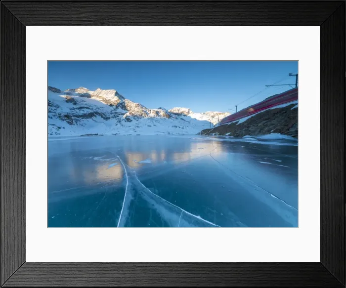 Framed Print : The Bernina Express train runs beside the frozen Lago Bianco, Bernina Pass, canton of Graubunden Framed Print : The Bernina Express train runs beside the frozen Lago Bianco, Bernina Pass, canton of Graubunden