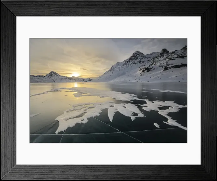 Framed Print : The frozen surface of Lago Bianco framed by snowy peaks at dawn, Bernina Pass, canton of Graubunden Framed Print : The frozen surface of Lago Bianco framed by snowy peaks at dawn, Bernina Pass, canton of Graubunden
