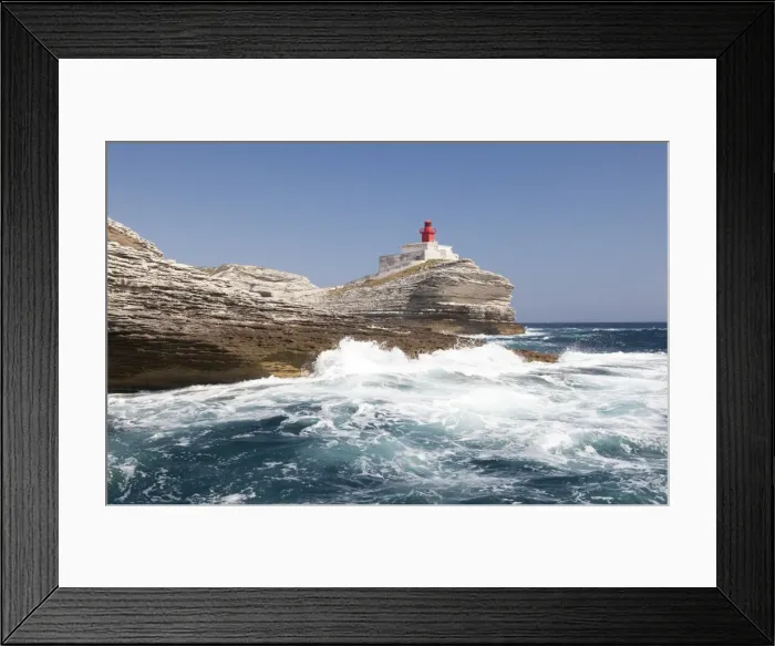 Framed Print : Waves of the turquoise sea crashing on the granite white cliffs and lighthouse, Lavezzi Islands
