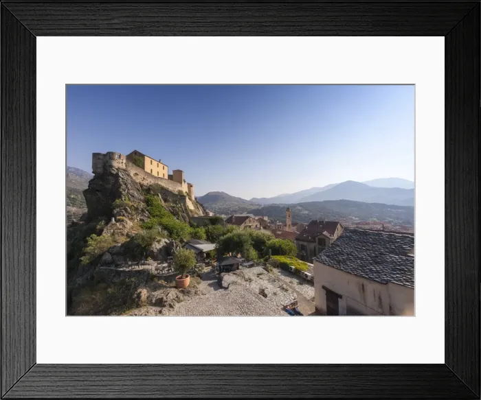 Framed Print : View of the old town of citadel of Corte perched on the hill surrounded by mountains Framed Print : View of the old town of citadel of Corte perched on the hill surrounded by mountains