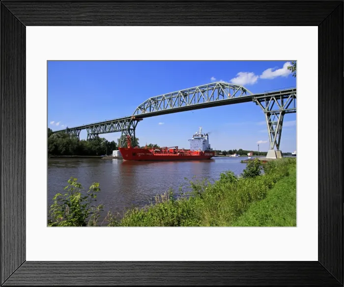 Framed Print : Ship on Kiel Canal going under the Railway Bridge of Hochdonn, Dithmarschen, Schleswig-Holstein Framed Print : Ship on Kiel Canal going under the Railway Bridge of Hochdonn, Dithmarschen, Schleswig-Holstein