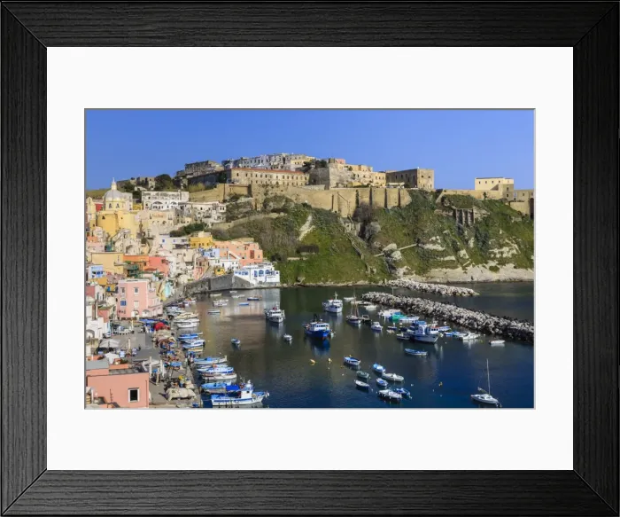 Framed Print : Marina Corricella, pretty fishing village, boats below Terra Murata acropolis fortress Framed Print : Marina Corricella, pretty fishing village, boats below Terra Murata acropolis fortress