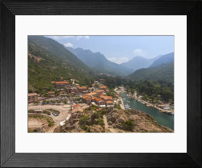 Framed Print : The typical village and harbor of Porto immersed in the green vegetation of the promontory Framed Print : The typical village and harbor of Porto immersed in the green vegetation of the promontory