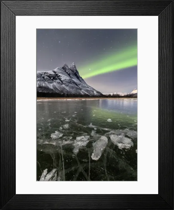 Framed Print : Ice bubbles of frozen sea and the snowy peak of Otertinden under the Northern Lights Framed Print : Ice bubbles of frozen sea and the snowy peak of Otertinden under the Northern Lights