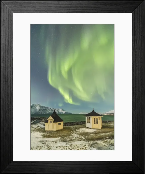 Framed Print : The Northern Lights (aurora borealis) and stars illuminate the wooden huts by icy sea Framed Print : The Northern Lights (aurora borealis) and stars illuminate the wooden huts by icy sea