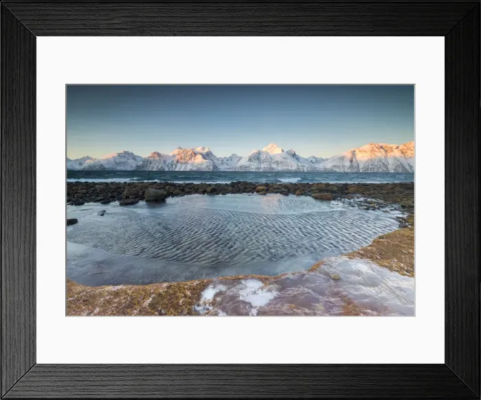 Framed Print : Rocks covered with ice frame the frozen sea surrounded by snowy peaks at dawn, Djupvik Framed Print : Rocks covered with ice frame the frozen sea surrounded by snowy peaks at dawn, Djupvik