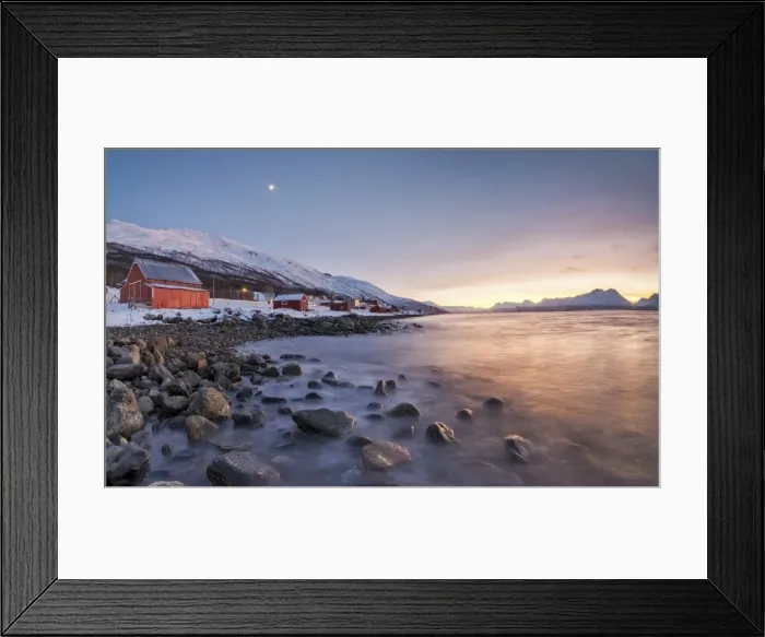 Framed Print : Panorama of typical wood huts called Rorbu framed by fiery sky at sunset and frozen sea Framed Print : Panorama of typical wood huts called Rorbu framed by fiery sky at sunset and frozen sea