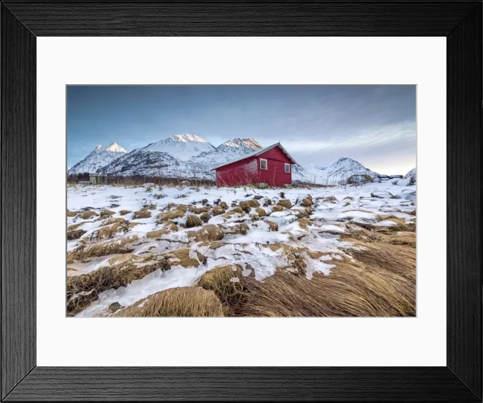 Framed Print : Wood hut framed by rocks covered with grass and ice with snowy peaks in the background Framed Print : Wood hut framed by rocks covered with grass and ice with snowy peaks in the background