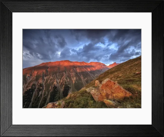 Framed Print : Dark clouds and sunset light frame the rocky peaks of Muottas Muragl, St. Moritz