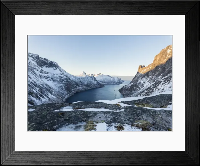 Framed Print : Top view of snowy peaks and frozen sea of the Ornfjorden surrounding the village of Fjordgard Framed Print : Top view of snowy peaks and frozen sea of the Ornfjorden surrounding the village of Fjordgard