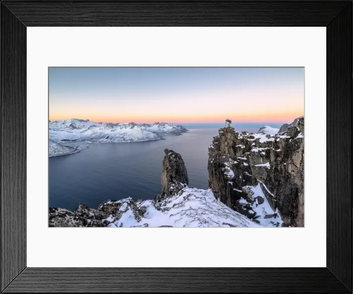 Framed Print : Photographer on the rocks on top of Mount Hesten admires the Mefjorden and the frozen Framed Print : Photographer on the rocks on top of Mount Hesten admires the Mefjorden and the frozen
