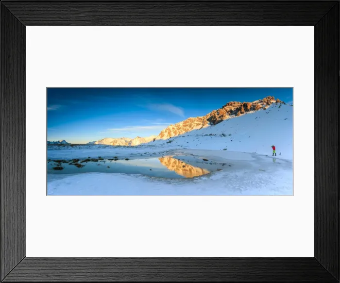 Framed Print : Panorama of Lake, Piz Umbrail at dawn with photographer in action framed by snow Framed Print : Panorama of Lake, Piz Umbrail at dawn with photographer in action framed by snow