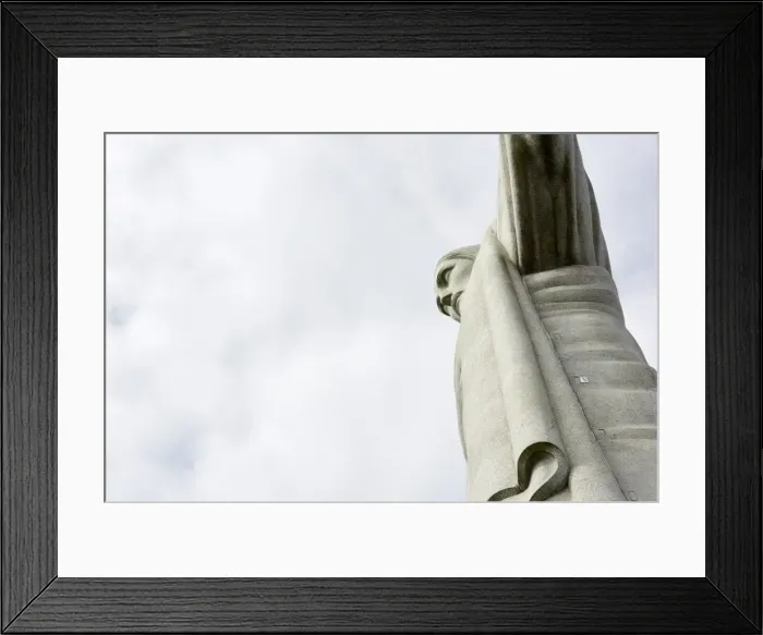 Framed Print : Low angle cropped shot of the iconic statue of Christ the Redeemer on a cloudy day Framed Print : Low angle cropped shot of the iconic statue of Christ the Redeemer on a cloudy day