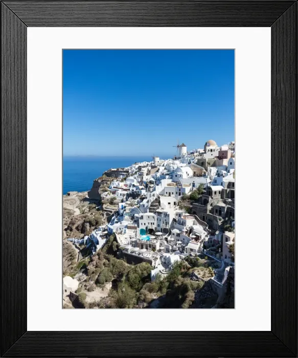 Framed Print : Day time view over the whitewashed buildings and windmill of Oia from the castle walls Framed Print : Day time view over the whitewashed buildings and windmill of Oia from the castle walls