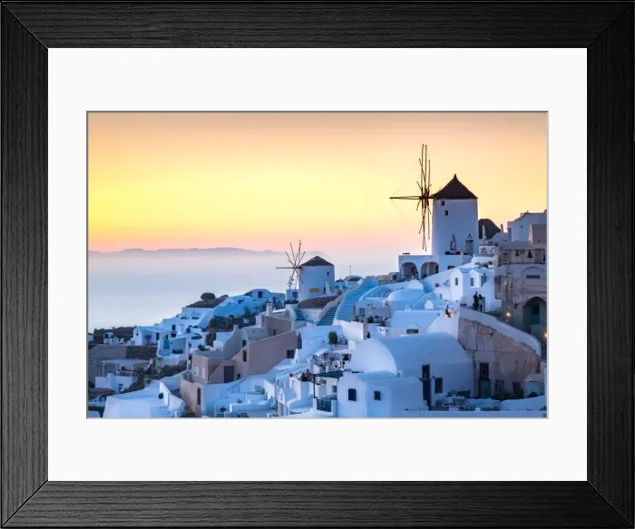 Framed Print : Sunset over the white stone buildings and windmills of Oia on the tip of Santorinis caldera Framed Print : Sunset over the white stone buildings and windmills of Oia on the tip of Santorinis caldera