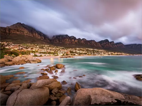 Long exposure at sunset at Camps Bay with cloud over Table Mountain and the Twelve Apostles