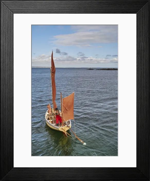 Framed Print : A fisherman sets out in his oyster dredger from Mousehole Harbour, Penwith, Cornwall Framed Print : A fisherman sets out in his oyster dredger from Mousehole Harbour, Penwith, Cornwall