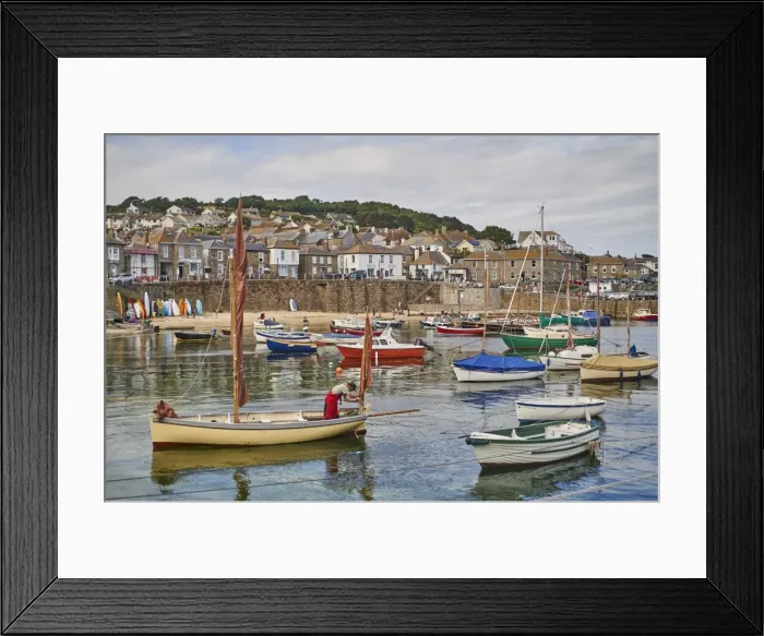 Framed Print : A fisherman makes ready his oyster dredger before setting out from Mousehole Harbour Framed Print : A fisherman makes ready his oyster dredger before setting out from Mousehole Harbour